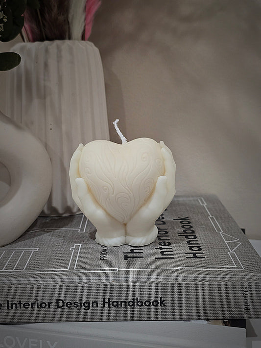 Hand holding Heart Candle